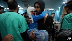 Palestinians wounded in the Israeli bombardment of the Gaza Strip are brought to Al Aqsa hospital in Deir al-Balah, Feb. 23, 2024.