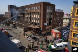 FILE - Medics and emergency staff work at the scene of a deadly blaze in downtown Johannesburg, Aug. 31, 2023.