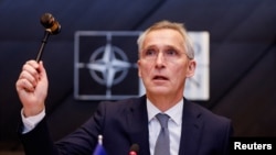 NATO Secretary General Jens Stoltenberg holds a gavel as he attends a meeting of the North Atlantic Council in the NATO defense ministers' session at the Alliance's headquarters in Brussels, Belgium, Feb. 15, 2024.