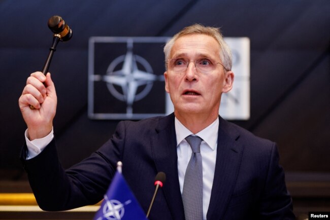 FILE - NATO Secretary General Jens Stoltenberg holds a gavel as he attends a meeting of the North Atlantic Council in the NATO defense ministers' session at the Alliance's headquarters in Brussels, Belgium, Feb. 15, 2024