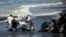 Workers from state owned Heritage Petroleum Oil and Gas Company clean up an oil spill that reached Rockly Bay beach, in Scarborough, southwestern Tobago, Trinidad and Tobago, Feb. 11, 2024. 