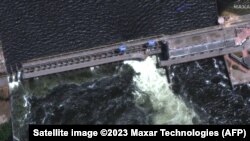 This handout satellite image courtesy of Maxar technologies shows a closer view of a destroyed roadway and section of the Nova Khakovka dam in south Ukraine, June 5, 2023. (Photo by Satellite image ©2023 Maxar Technologies / AFP) 