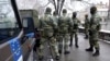 FILE - NATO peacekeeping EUFOR troops stop as they patrol in downtown Sarajevo, Bosnia, March 7, 2022. 