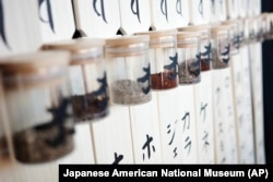FILE - In this photo provided by the Japanese American National Museum, soil from the seventy-five internment camps for Japanese Americans in World War II, is displayed at the museum in Los Angeles, Sept. 24, 2022.