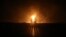 Two men look at flames after a natural gas pipeline exploded outside the city of Boroujen in the western Chaharmahal and Bakhtiari province, Iran, Feb. 14, 2024. 
