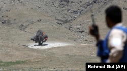 (FILE) Smoke rises after a controlled detonation of land-mines and other ammunition in Afghanistan.