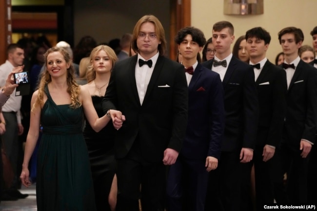 Students of Warsaw's Mikolaj Rej high school dance Poland's national polonaise dance to open their pre-graduation ball in Warsaw, Poland, on Feb. 3, 2024. (AP Photo/Czarek Sokolowski)