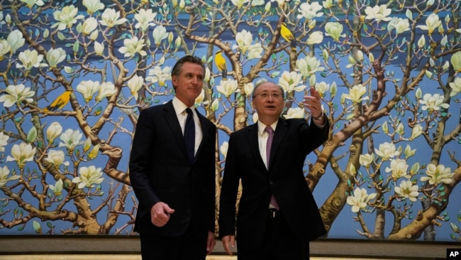 California Gov. Gavin Newsom, left, stands next to Beijing Party Secretary Yin Li during a meeting in Beijing, Oct. 26, 2023. Newsom was on a weeklong tour of China.