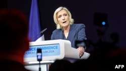 Former president of the French far-right Rassemblement National (RN) parliamentary group Marine Le Pen gives a speech during the results evening of the first round of the parliamentary elections in Henin-Beaumont, northern France, June 30, 2024. 