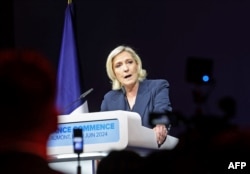 Former president of the French far-right Rassemblement National (RN) parliamentary group Marine Le Pen gives a speech during the results evening of the first round of the parliamentary elections in Henin-Beaumont, northern France, June 30, 2024.
