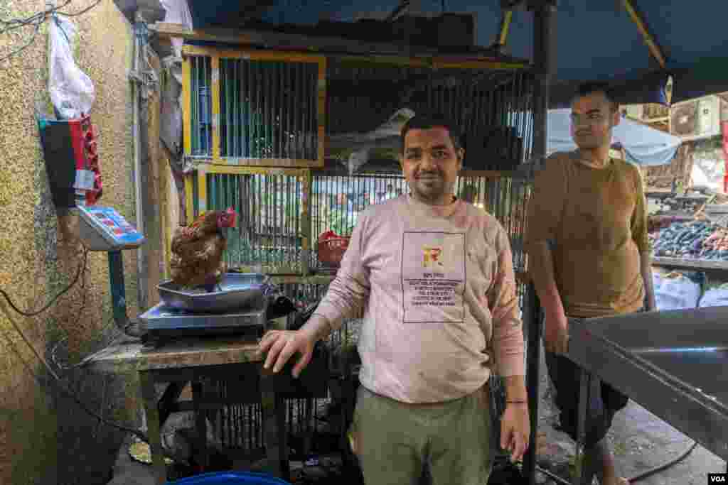 Moksha, left, a poultry butcher, is seen in Cairo, March 28, 2023. &quot;Last Ramadan, I sold around 500 kilograms of chicken each day &mdash; now, if I sell 100 kilograms, I would call myself lucky,&quot; Moksha said. (Hamada Elrasam/VOA)&nbsp;