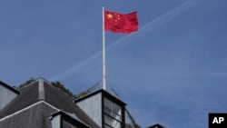 FILE - Chinese national flag is raised at the Chinese embassy in London, Sept. 11, 2023.