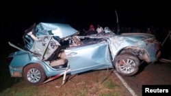 The wreckage of the vehicle in which Kelvin Kiptum and his coach Gervais Hakizimana were killed is being pulled from its crash site on a road near the Rift Valley town of Eldoret, Kenya, Feb. 12, 2024.