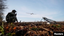 A member of the 15th Separate Artillery Reconnaissance Brigade of the Ukrainian armed forces launches a Shark drone amid Russia's attack on Ukraine, in Kharkiv region, Oct. 30, 2023.