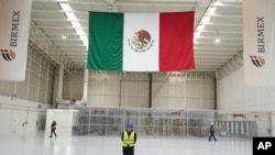 Workers stand inside a 'mega-pharmacy' warehouse in Huehuetoca, Mexico, Dec. 29, 2023. 