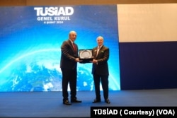 Rahmi Koç, TÜSİAD yönetimlerinde yer alan ve son dokuz yıldır Yüksek İstişare Konseyi Başkanı olan Tuncay Özilhan’a plaket verdi.