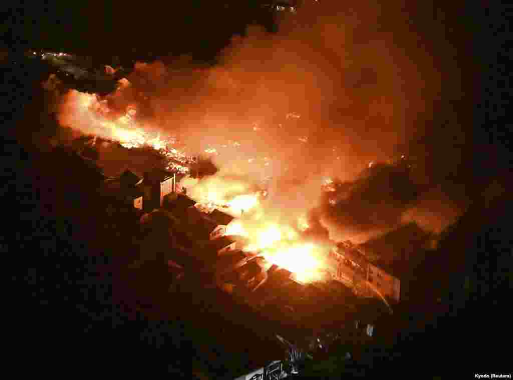 An aerial view shows a fire site after an earthquake at a residential area in Wajima, Ishikawa prefecture, Japan, in this photo released by Kyodo.