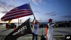 Trang Le of Orlando, right, and Maria Korynsel of North Palm Beach show their support for former President Donald Trump after the news broke that Trump had been indicted by a Manhattan grand jury, March 30, 2023, in Palm Beach, Fla.