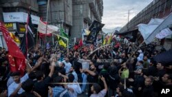 Shiite Muslims shout religious slogans as they participate in a Muharram procession in Srinagar, Indian-controlled Kashmir, on July 27, 2023. Muharram is a month of mourning for Shiite Muslims in remembrance of the martyrdom of Imam Hussein, grandson of the Prophet Muhammad.