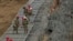 Guardsmen fortify the border along the Rio Grande with concertina wire, Feb. 2, 2024, in Eagle Pass, Texas. 