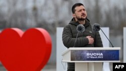 Ukrainian President Volodymyr Zelenskyy attends a ceremony marking the first anniversary of the retreat of Russian troops from the Ukrainian town of Bucha, in Bucha, near Kyiv, on March 31, 2023.