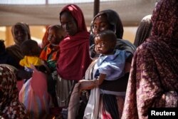 FILE - Women and babies are seen at the Zamzam displacement camp, home to 400,000, in North Darfur, Sudan, in January 2024.