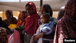 FILE - Women and babies are seen at the Zamzam displacement camp, home to 400,000, in North Darfur, Sudan, in January 2024. Doctors Without Borders found two babies were dying every hour there, and nearly 40% of children 6 months to 2 years old were malnourished.