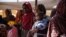 FILE - Women and babies are seen at the Zamzam displacement camp, home to 400,000, in North Darfur, Sudan, in January 2024. Doctors Without Borders found two babies were dying every hour there, and nearly 40% of children 6 months to 2 years old were malnourished.