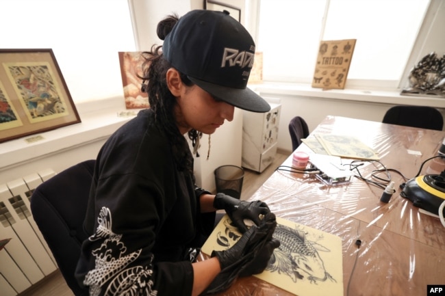 A student training to be a tattoo artist practices on a silicon canvas at a studio in Tehran, Iran, on Nov. 7 2023.