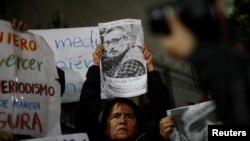 FILE - A woman holds the picture of Mexican journalist Luis Martin Sanchez, whose body was found on the outskirts of the city of Tepic, during a protest on July 10, 2023, to demand justice for him, outside the Interior Ministry building in Mexico City.