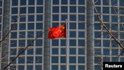 A Chinese flag flutters outside the Chinese foreign ministry in Beijing, China, Feb. 24, 2022.