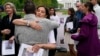 FILE - Neda Shargi, sister of Iranian prisoner Emad Shargi, hugs former Syrian hostage Sam Goodwin before a news conference with families of Americans wrongfully detained overseas in Lafayette Park near the White House, May 4, 2022, in Washington.