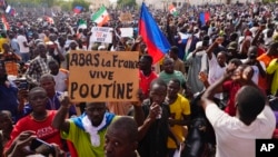 Nigeriens participate in a march called by supporters of coup leader Gen. Abdourahmane Tchiani in Niamey, Niger, July 30, 2023. 