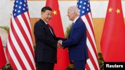 FILE - U.S. President Joe Biden, right, shakes hands with Chinese President Xi Jinping on the sidelines of a G20 summit in Bali, Indonesia, Nov. 14, 2022. 