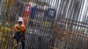 FILE - Construction workers help erect a building in Miami, June 14, 2023. Construction workers say they are losing their jobs because employers fear Florida's new immigration law.