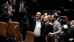 Israeli lawmakers celebrate by taking a selfie after approving a key portion of Prime Minister Benjamin Netanyahu's divisive plan to reshape the country's justice system, on the floor of the Knesset, Israel's parliament, in Jerusalem, July 24, 2023.