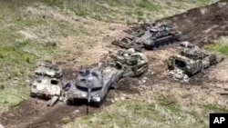 This photo taken from video on June 9, 2023, shows Ukrainian military vehicles being hit during combat in Ukraine. (Russian Defense Ministry Press Service via AP)