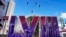 People ride a zip line above a sign for the Super Bowl ahead of the Super Bowl 58 NFL football game, Feb. 2, 2024, in Las Vegas.