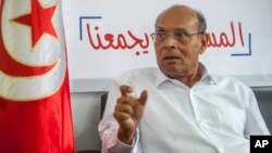 FILE — Former Tunisian President and head of el-Harak party Moncef Marzouki speaks to The Associated Press in Tunis, on Aug. 28, 2019. 