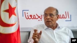 FILE — Former Tunisian President and head of el-Harak party Moncef Marzouki speaks to The Associated Press in Tunis, Tunisia, Aug. 28, 2019. A court in Tunisia sentenced Marzouki to prison in absentia as part of the country's crackdown on opponents of President Kais Saied. 