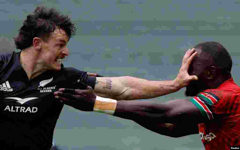 New Zealand's Leroy Carter is seen in action with Kenya's Herman Humwa during a rugby match, at the Sevens World Cup in Hong Kong.