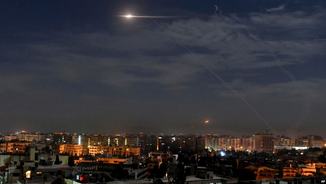 FILE - In this photo released by the Syrian official news agency SANA, shows missiles flying in the sky near Damascus International Airport, in Damascus, Syria, Jan. 21, 2019.