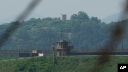 A North Korean military guard post, background, and a South Korean post, front, are seen in Paju, South Korea, July 20, 2023.