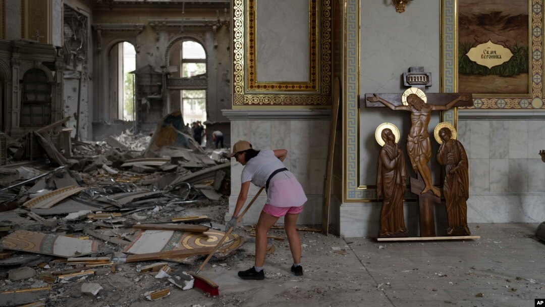 A woman helps clean up inside the Spaso-Preobrazhensky (Lord's Transfiguration) Cathedral after it was heavily damaged in Russian missile attacks in Odesa, Ukraine, July 23, 2023.