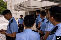 Polisi berjaga di luar Pengadilan Tinggi jelang sidang putusan pelarangan lagu protes 2019 "Glory to Hong Kong" di Hong Kong, Jumat, 21 Juli 2023. (AP Photo/Louise Delmotte)