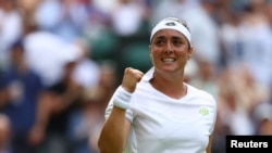 Tunisia's Ons Jabeur celebrates winning her fourth round match against Czech Republic's Petra Kvitova at the All England Lawn Tennis and Croquet Club, London, Britain on July 10, 2023