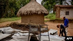 People visit the Mukondi health center burned during an attack attributed to the ADF in Mukondi, about 30 kilometers from the town of Beni in eastern Democratic Republic of Congo, on March 10, 2023.