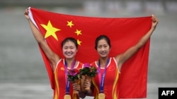 Gold medalists Lu Shiyu and Shen Shuangmei of China pose for a photo during a medal ceremony after the women's double sculls final event of rowing during the 2022 Asian Games in Hangzhou in China's eastern Zhejiang province on Sept. 24, 2023.