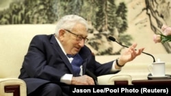 FILE - Former U.S. Secretary of State Henry Kissinger speaks during a meeting at the Great Hall of the People in Beijing, China, Nov. 22, 2019. The 100-year-old veteran U.S. diplomat also met with a Chinese official on Tuesday. (Jason Lee/Reuters/Pool Photo) 