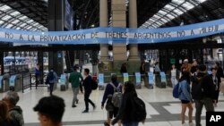 A banner reading in Spanish: 'No to the privatization of Argentine trains, no to Milei' hangs at the Retiro train station in Buenos Aires, Argentina, Nov. 18, 2023.